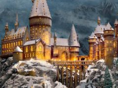 Hogwarts Castle in a winter setting Thomas Kinkade painting.